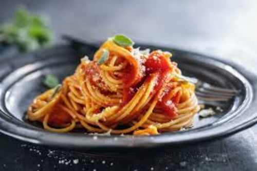 Spaghetti with tomato sauce on a dark plate