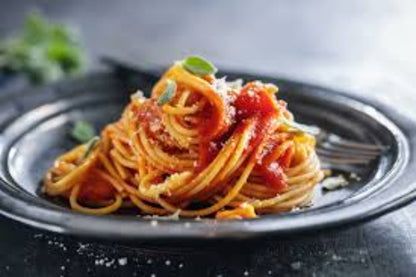 Spaghetti with tomato sauce on a dark plate